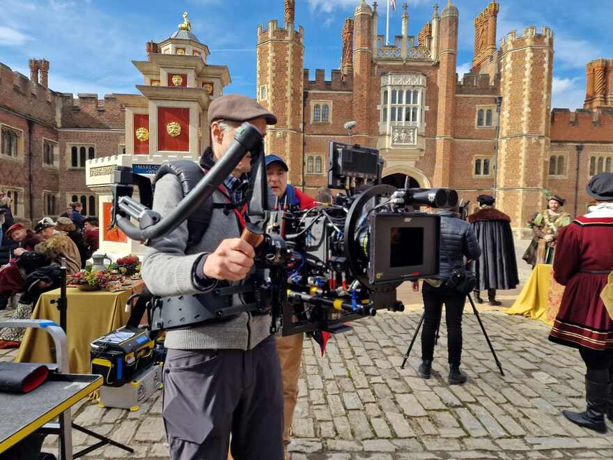 A trainee at the edge of a working set, call sheet in hand