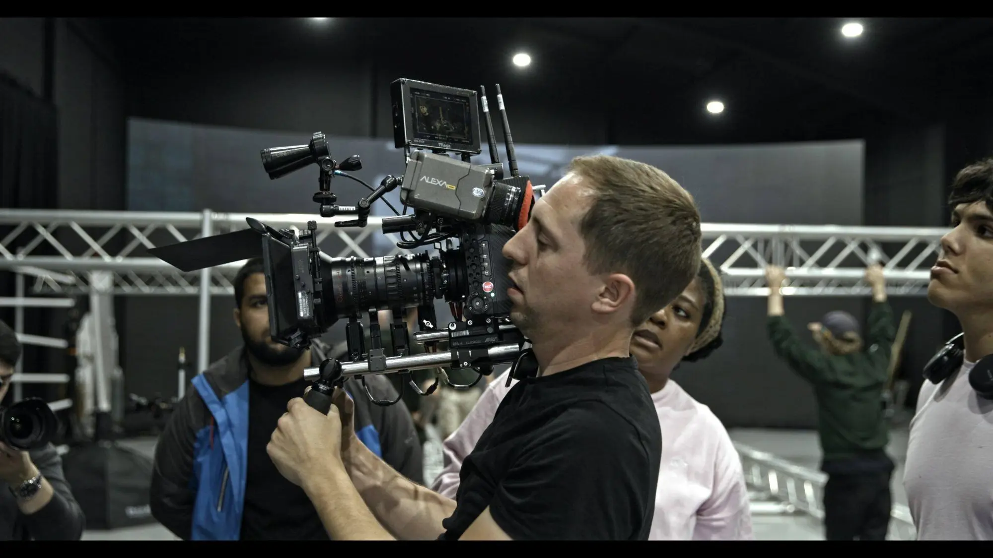 Operator on the camera, crew around him